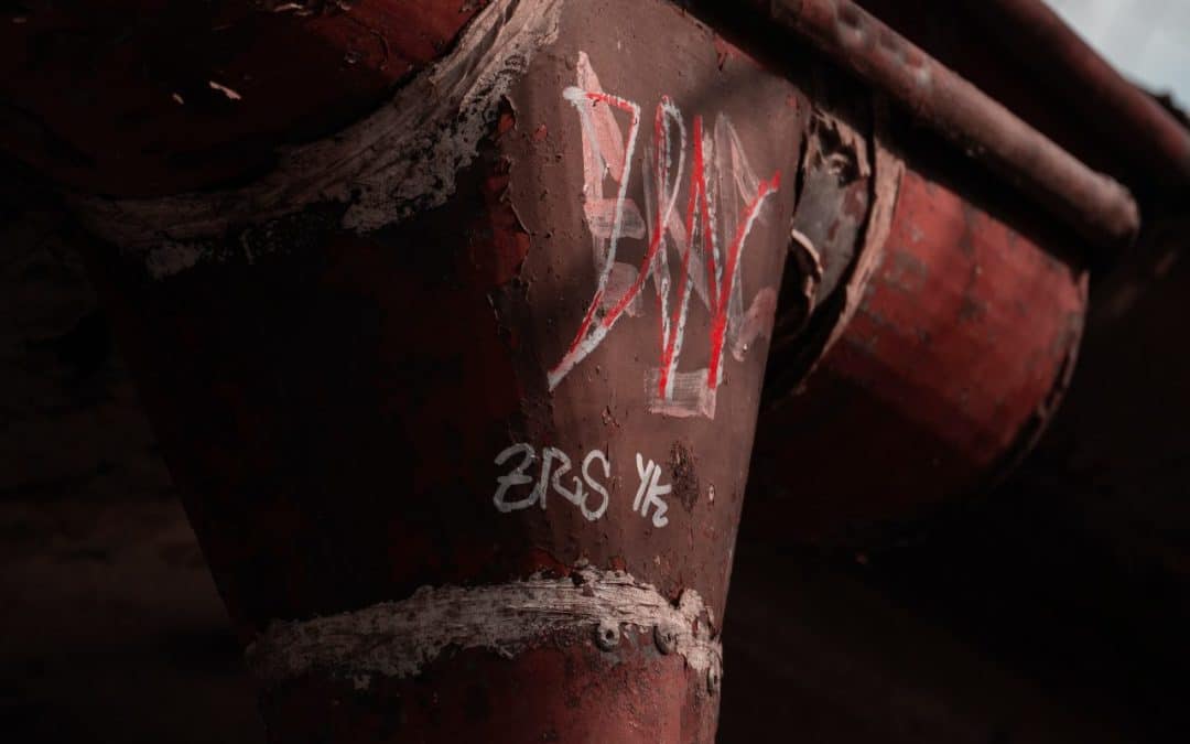 Red gutter pipe with writing on it