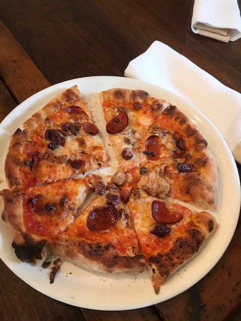 Our team's pepperoni pizza sits on a plate beside a napkin.