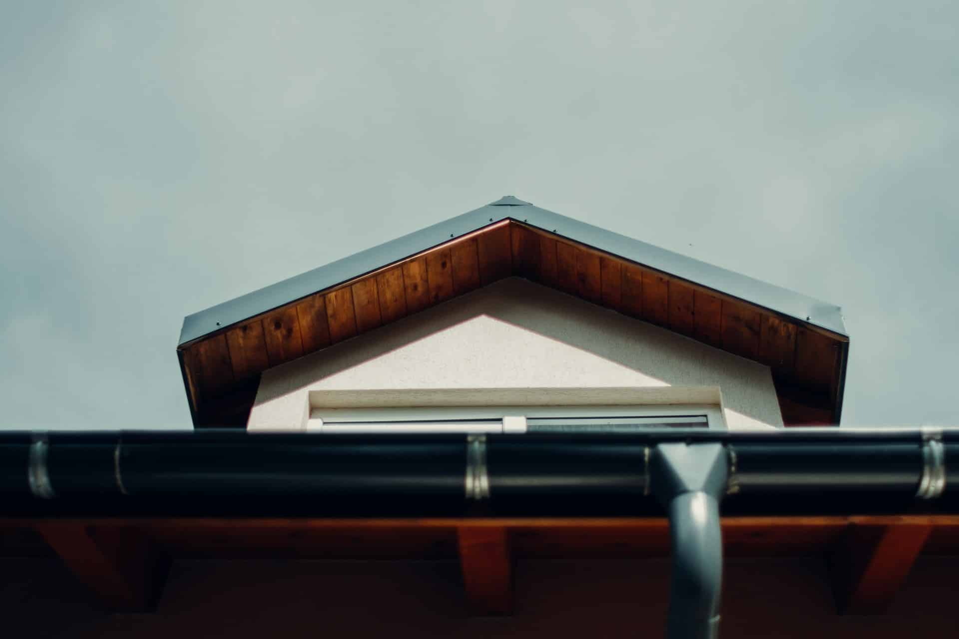 Looking up at roof with black gutter